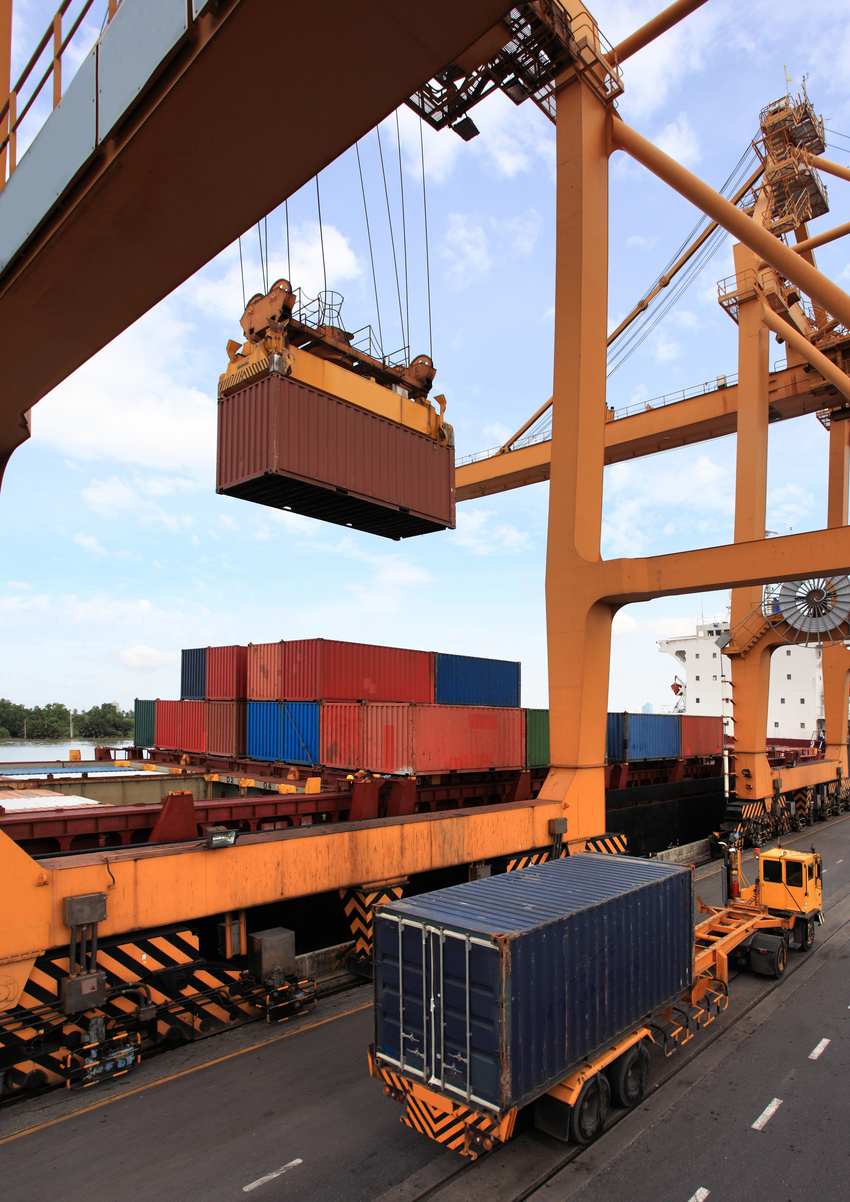 Gantry crane loading a container onto a vessel in Spain