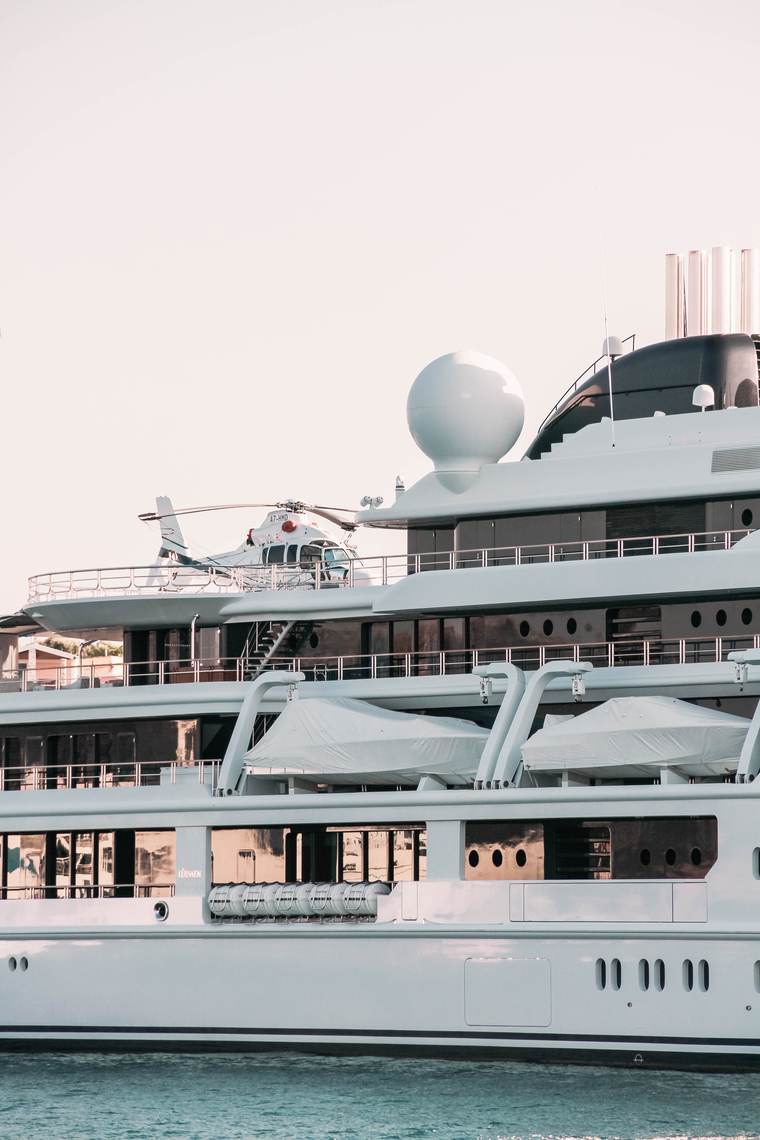 Superyacht moored in a Spanish port at dusk
